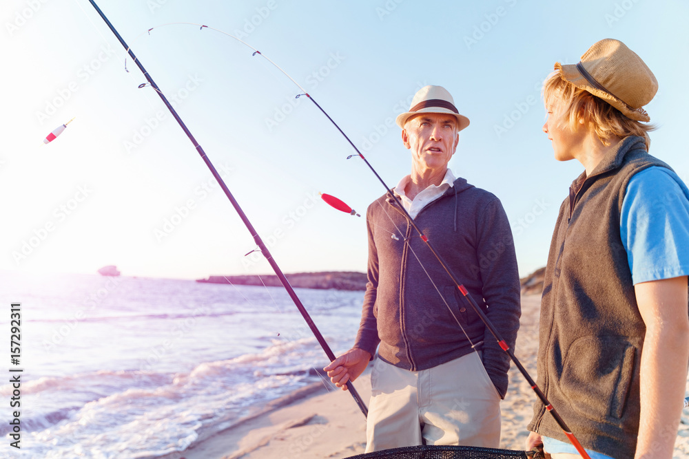 Senior man fishing with his grandson Senior man fishing with his grandson