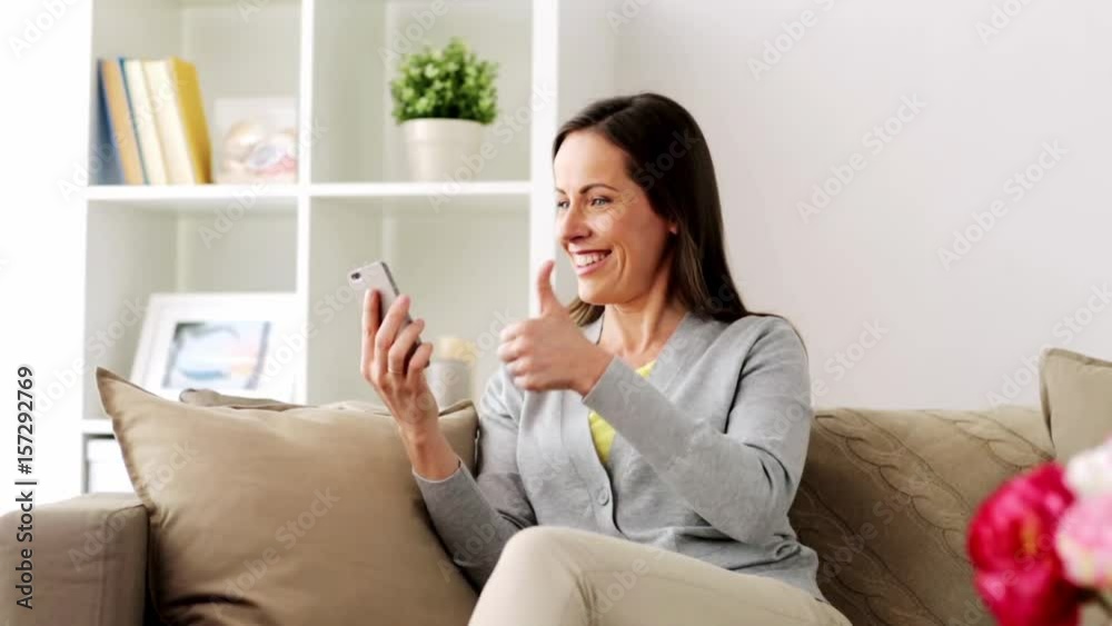 woman having video chat on smartphone at home woman having video chat on smartphone at home