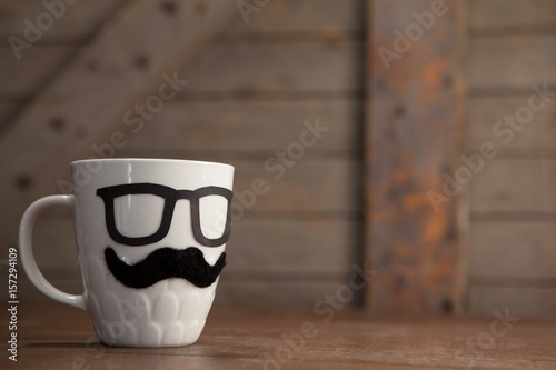 Close up of white coffee mug with mustache