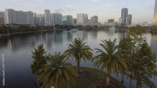 Aerial reveal flying forward & up over Lake Eola fountain in downtown, Orlando, FL.  