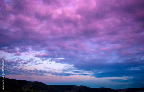 Photo of a violet sunset with clouds