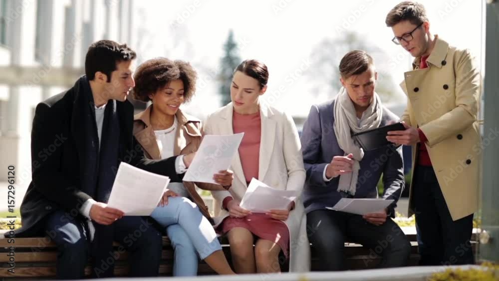 international business team with papers outdoors international business team with papers outdoors