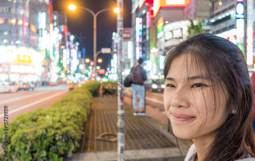 Canvas Print Female Tourist are traveling in Shinjuku Shopping district.