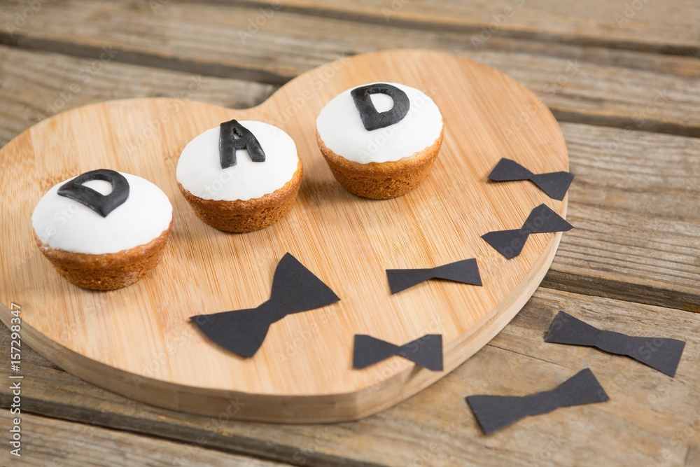Close up of cupcakes with dad text by bow tie Close up of cupcakes with dad text by bow tie