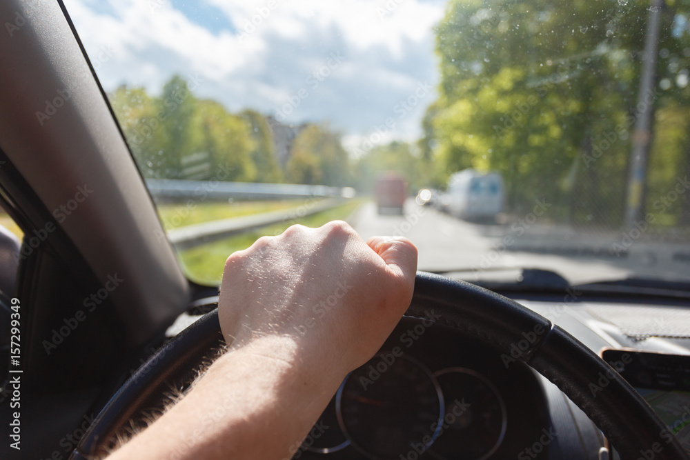 custom made wallpaper toronto digitalMale hand on the steering wheel while the car is in motion in park.