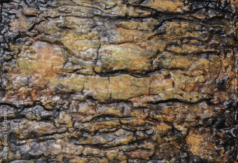 Texture background deeply grooved and painted by hand in orange, black, green, and yellow Texture background deeply grooved and painted by hand in orange, black, green, and yellow