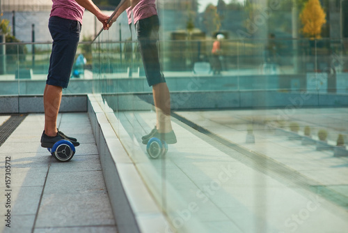 Male legs on gyroscooter. Person standing on hoverboard. Buy mini segway.