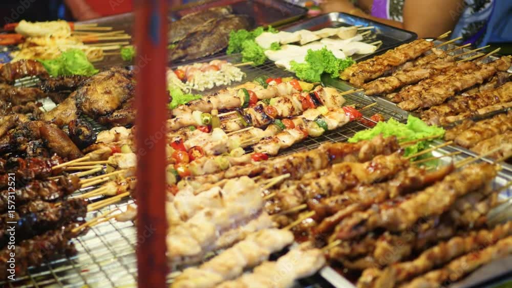 Traditional Asian meat satay street food cooking outdoor at night. South East Asia
