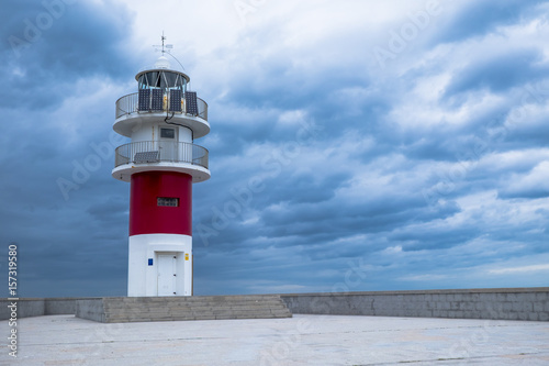 View of small Lighthouse Against Storm Clouds