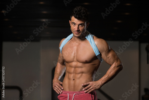 Handsome Muscular Man Flexing Muscles In Gym