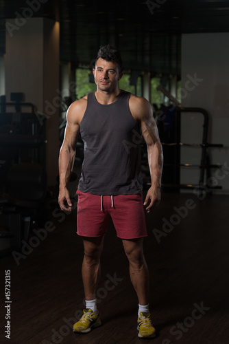 Fitness Model In Undershirt Flexing Muscles