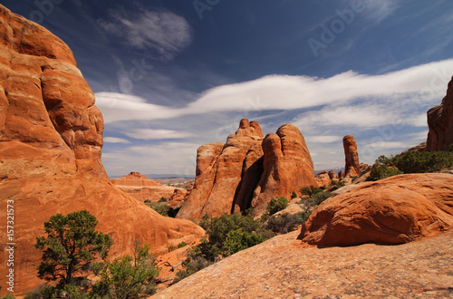 Sandstone formations in Arches National Park under partly cloudy skies.