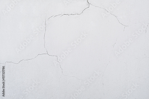 On the wall a lot cracks on a beige plaster