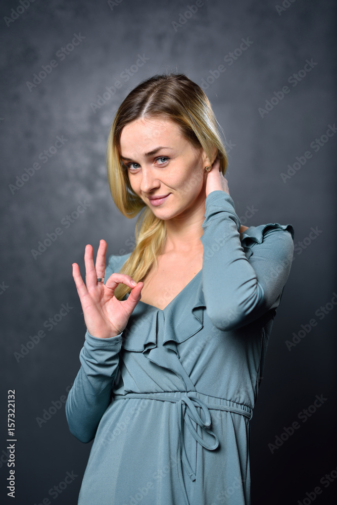 Girl shows a sign with his hands that everything will be fine Girl shows a sign with his hands that everything will be fine