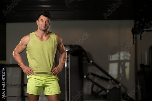 Strong Man in Green T-shirt Background Gym