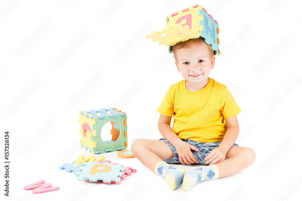 Happy preschool child learning to read playing with colorful alphabet letters. Happy preschool child learning to read playing with colorful alphabet letters.