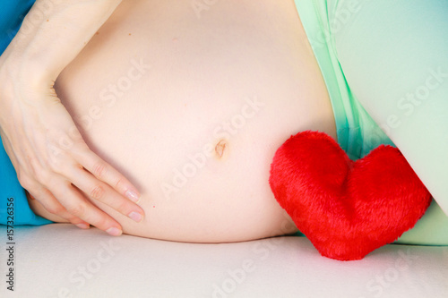 Wallpaper Mural Pregnant woman lying on couch touching her belly Torontodigital.ca