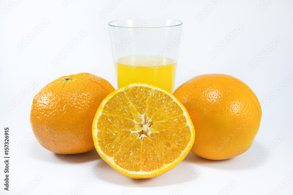 Perfectly retouched sliced orange in the middle. Fresh oranges isolated on white background. Freshly picked oranges. Orange juice. Glass of orange juice. Close up. Perfectly retouched sliced orange in the middle. Fresh oranges isolated on white background. Freshly picked oranges. Orange juice. Glass of orange juice. Close up.