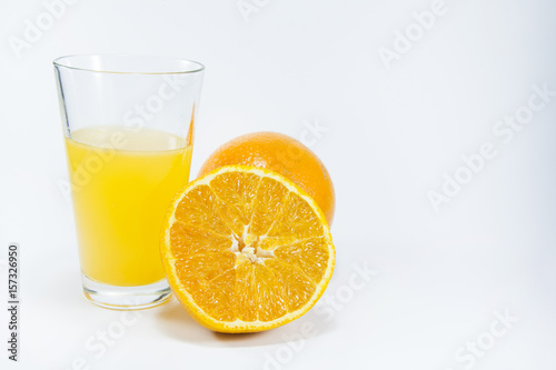 Perfectly retouched sliced orange in the middle. Fresh oranges isolated on white background. Freshly picked oranges. Orange juice. Glass of orange juice. Close up.