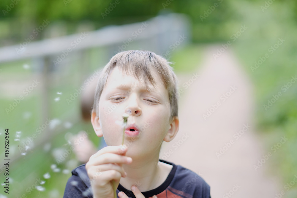 Portrait of a child with a dandelion on a walk Portrait of a child with a dandelion on a walk