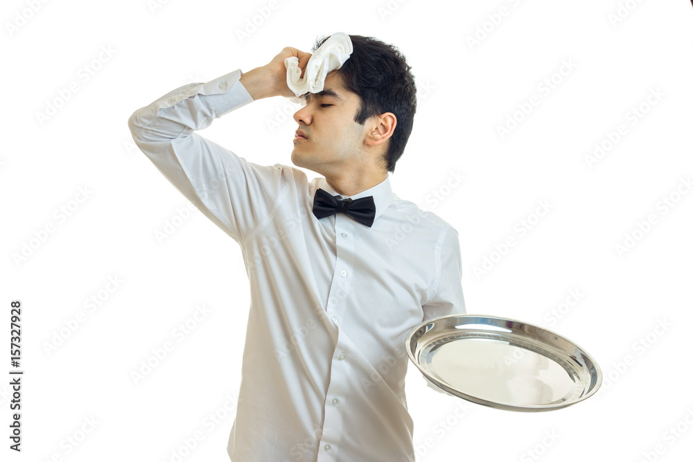tired brunette waiter man in unifrom with silver tray in hand tired brunette waiter man in unifrom with silver tray in hand