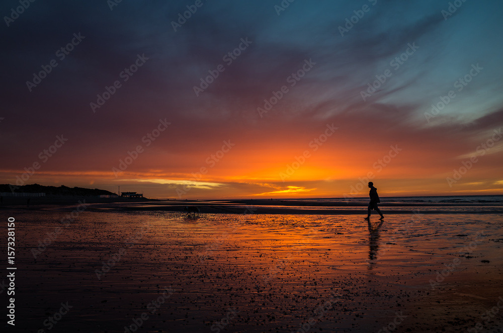 Sunset at seashore with man