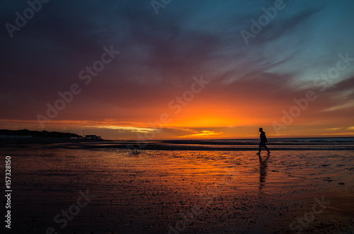 Sunset at seashore with man