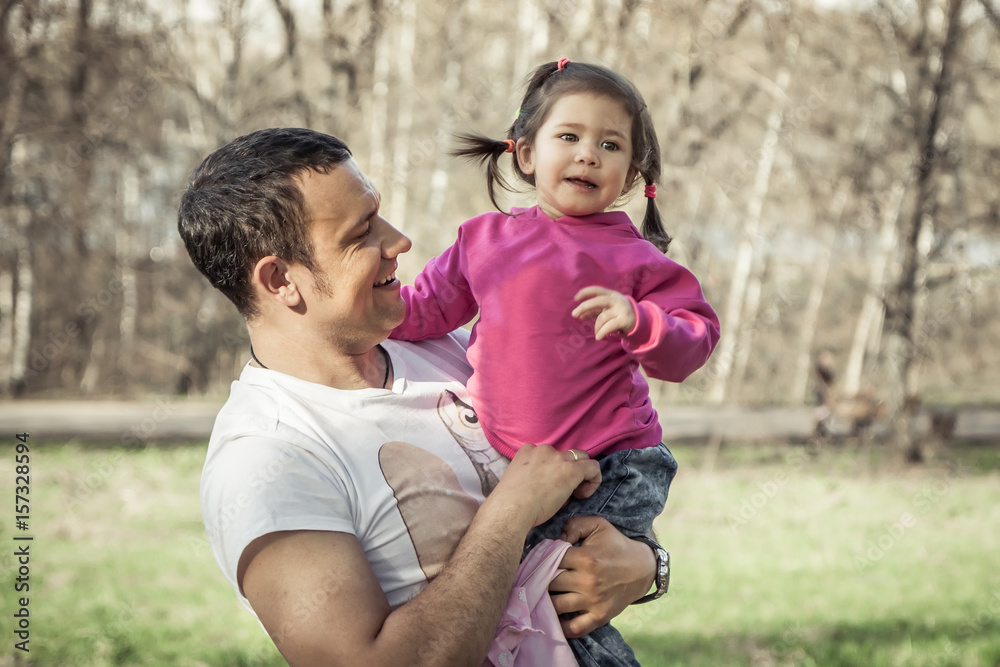 Family portrait of cheerful child and happy smiling dad looking on his daughter Family portrait of cheerful child and happy smiling dad looking on his daughter