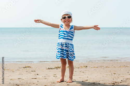 Happy cute little girl on the seashore