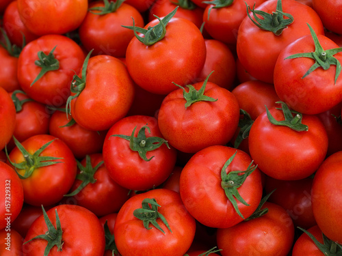 Delicious fresh red tomatoes. Summer market full of organic tomatoes. It can be used as background. © Aleksei
