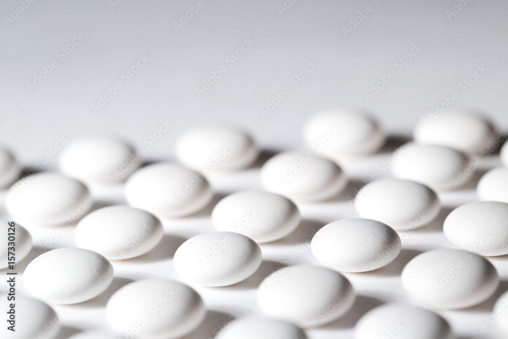 White tablets - abstract medical background.
