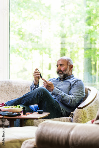 Mature, diabetic, ethnic man in his 50's checking his blood sugar