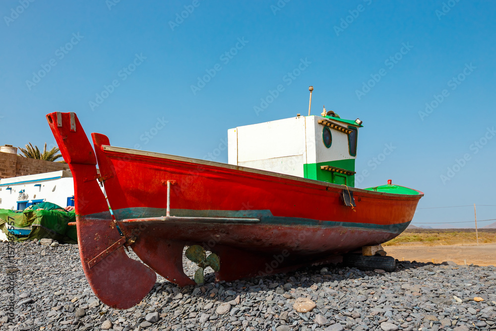 Old red fishing boat on the beach