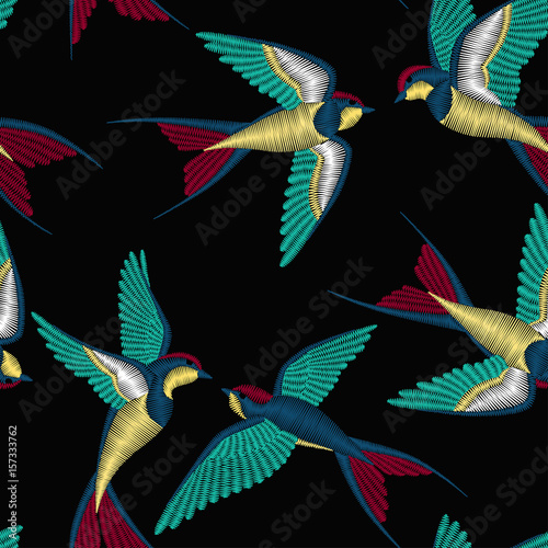 Embroidery seamless pattern with beautiful swallow birds. Vector embroidery for fashion textile and fabric.