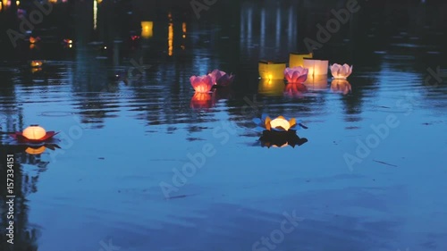 Slowmotion of water glowing lanterns festival on the river in Asia photo