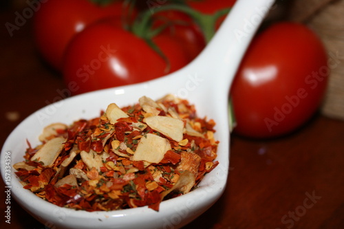 spoonful of aglione spices...blurred tomato's in background