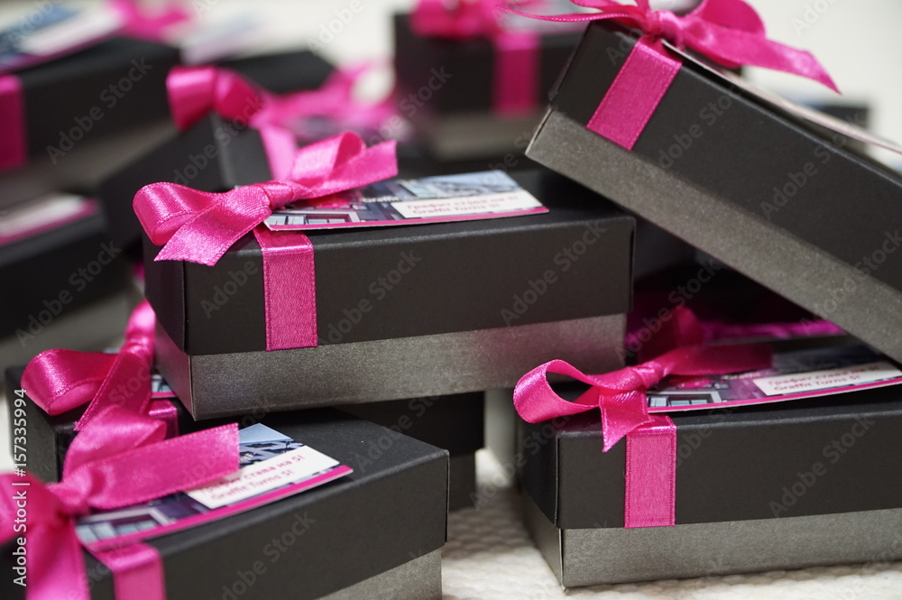Black and grey giveaway boxes with ribbons - obrazy, fototapety, plakaty 