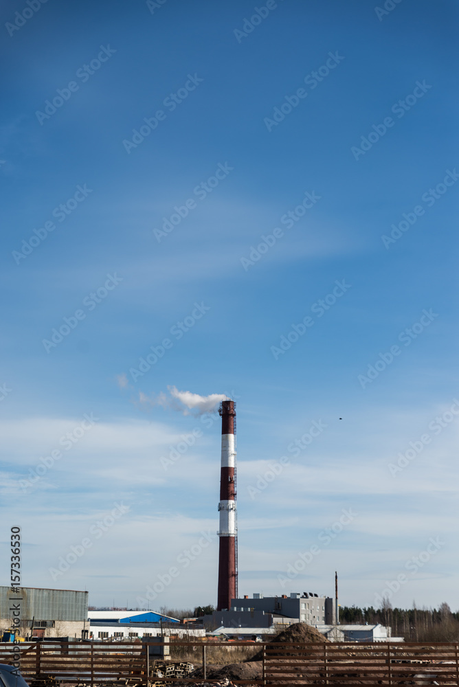 factory chimney releasing white smoke