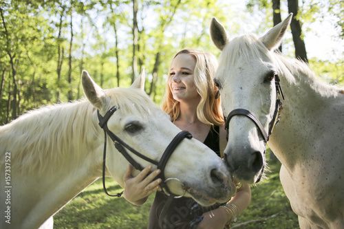Portrait of a Female with Blond Hair and Two White Horses