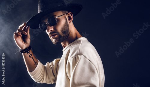 Photography Cool stylish handsome man wearing sunglasses holding hat