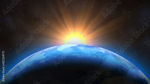 Fototapeta Naklejka Na Ścianę i Meble -  Sunrise over the Earth. Imaginary view of planet earth in outer space with the rising sun.