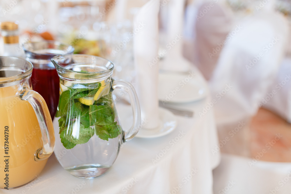Jugs full of refreshing lime drink on some festive event or catered dinner Jugs full of refreshing lime drink on some festive event or catered dinner