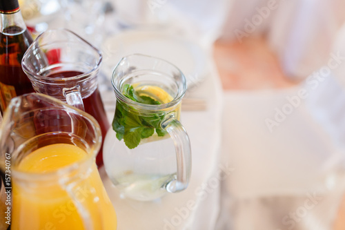 Summer fresh drinks in pitchers among other juices served on the table.