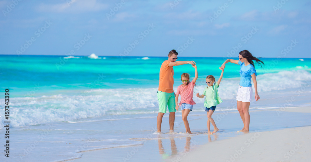Beautiful family have a lot of fun on the beach