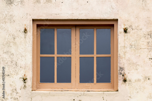 Wood framed windows on plaster wall