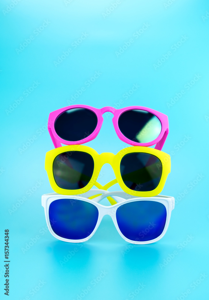 Stack of  Sunglasses in light blue studio,Summer Time concept,Leave space for adding your content or text