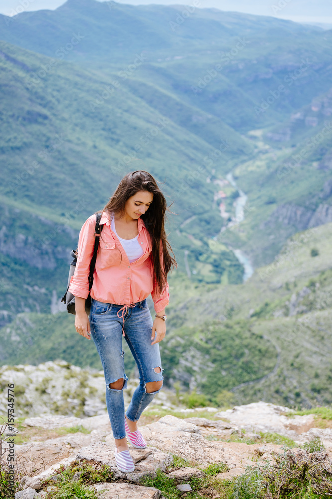 joyful woman travel mountains with backpack