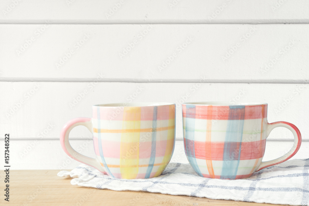 Coffee cup put on wooden in white wood wall with copy space. Coffee cup put on wooden in white wood wall with copy space.