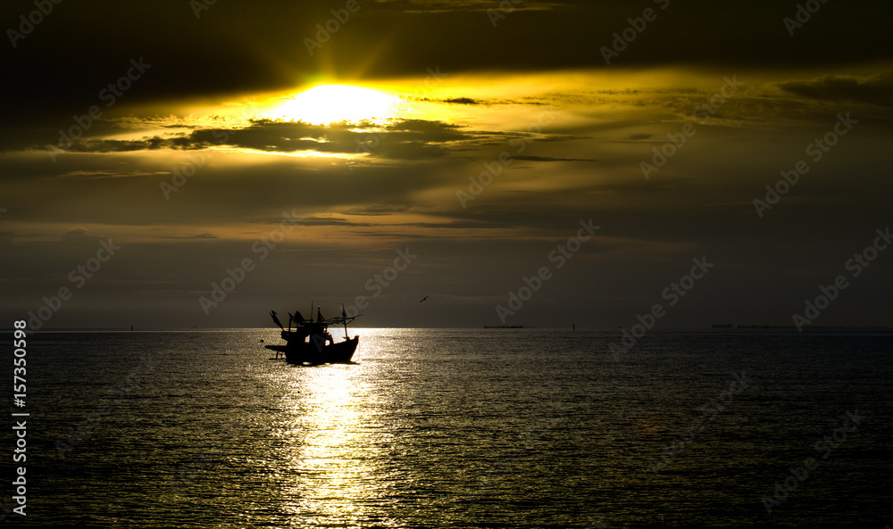 Beautiful sunset shine to the boat that float on the sea in summer time