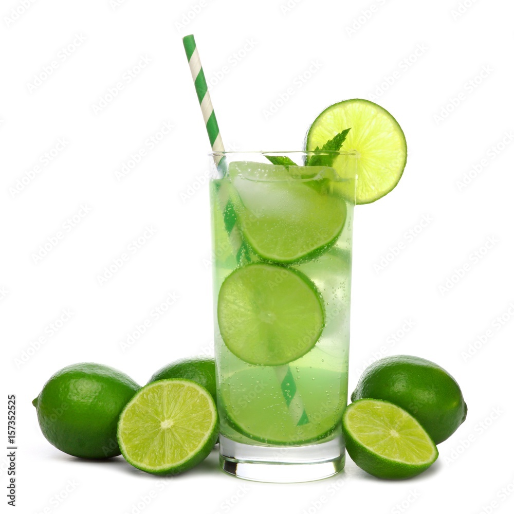 Glass of sparkling limeade with straw and limes isolated on a white background